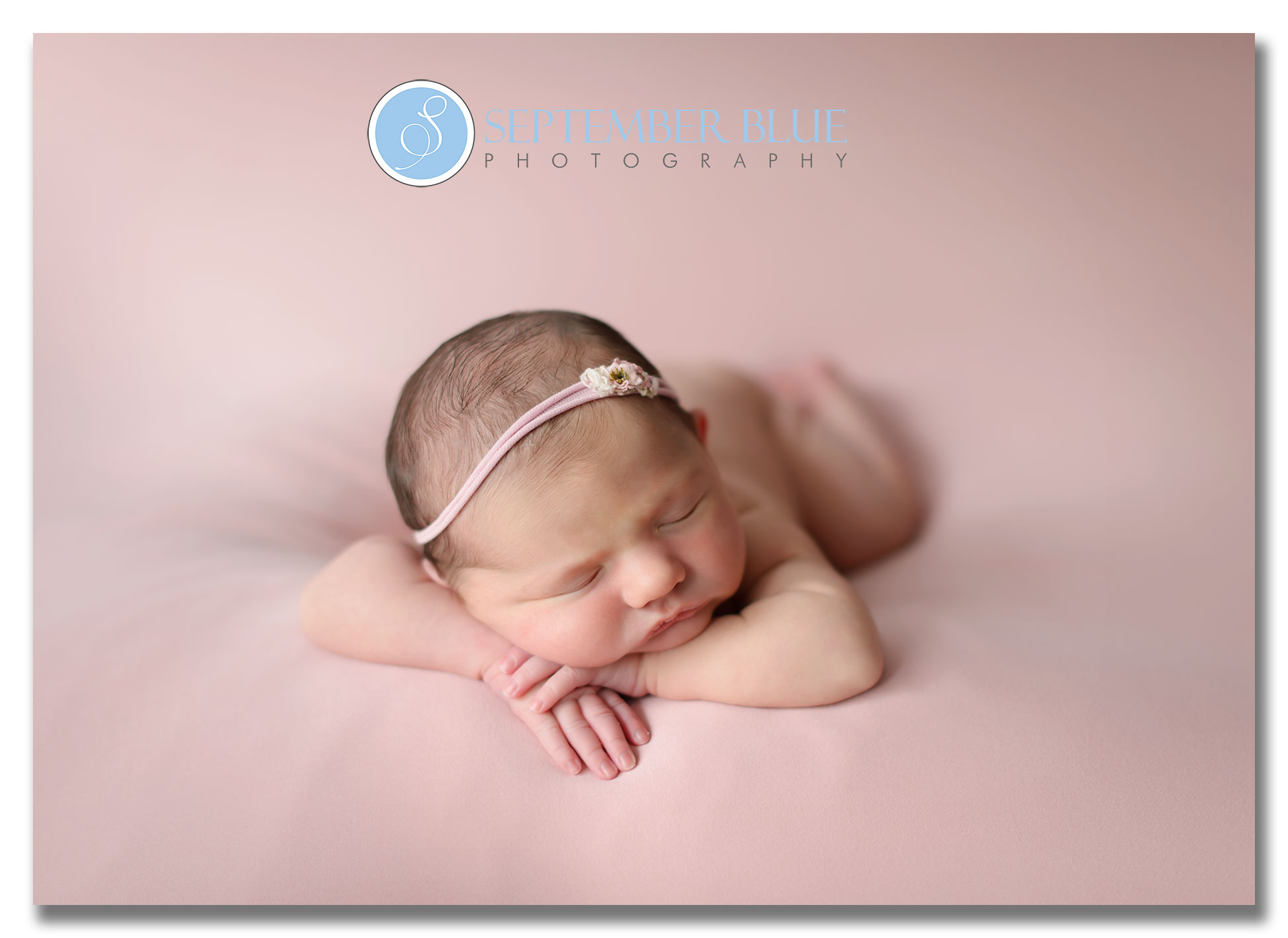 Newborn girl in chin pose
